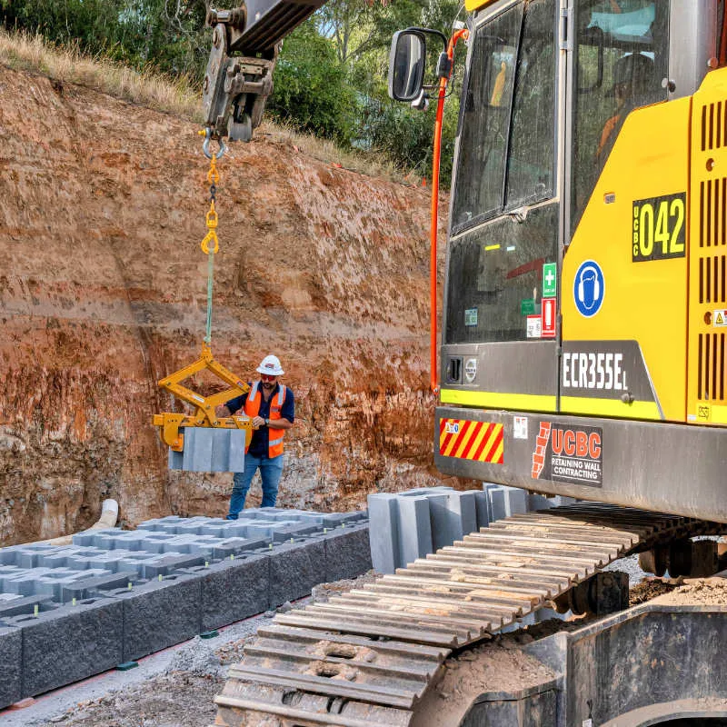 Rock and boulder retaining wall on a landscaped batter