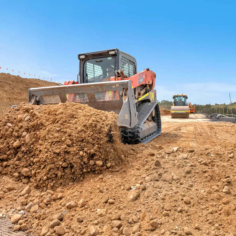 UCBC excavator and operator placing precast retaining wall units