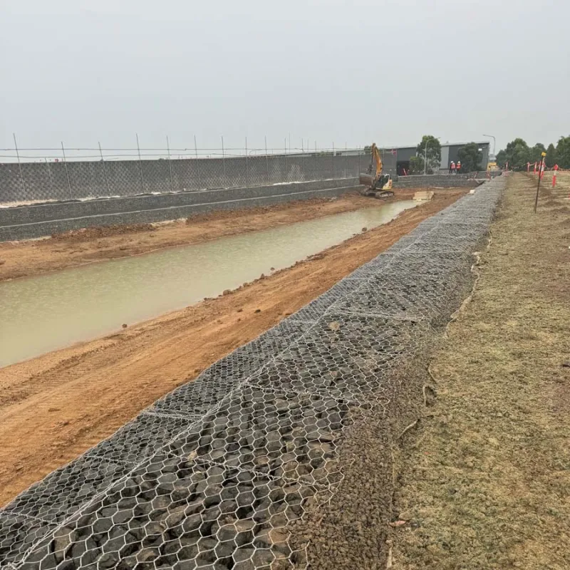Rock-filled gabion basket retaining wall